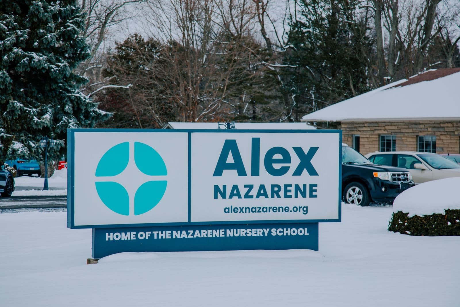 The Alex Nazarene sign in the snow, reading Home of the Nazarene Nursery School